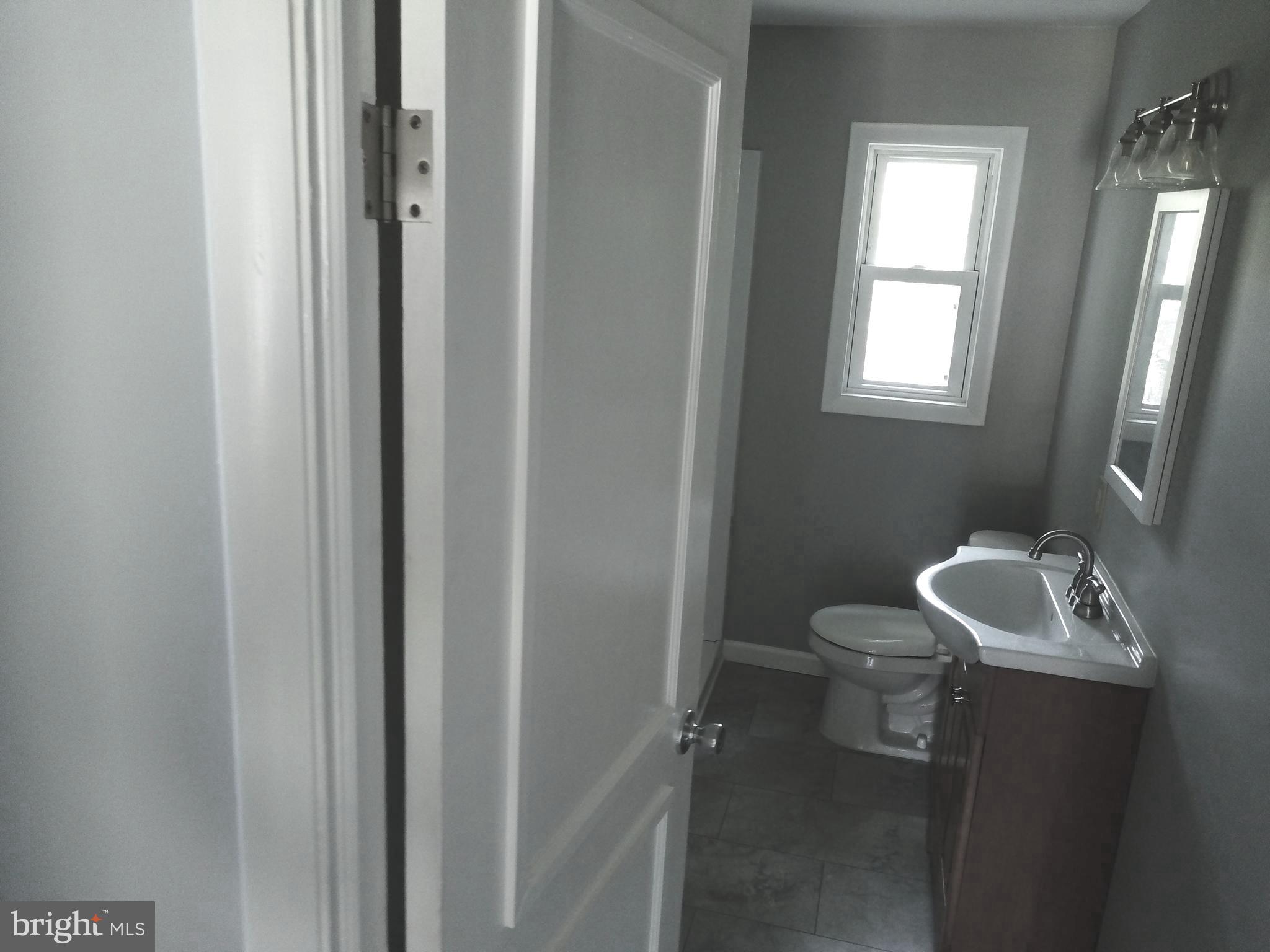 13 Meehan Boulevard Clementon, NJ 08021 - Photo 19 of 32 a bathroom with a sink a toilet and a mirror