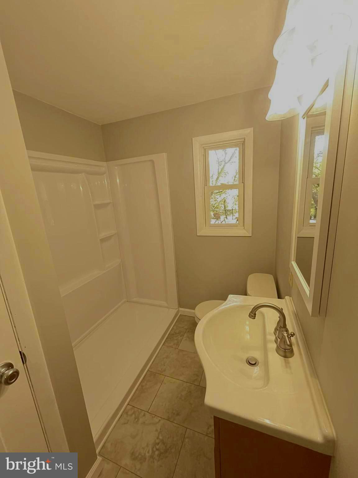 13 Meehan Boulevard Clementon, NJ 08021 - Photo 20 of 32 a bathroom with a sink a shower and a mirror