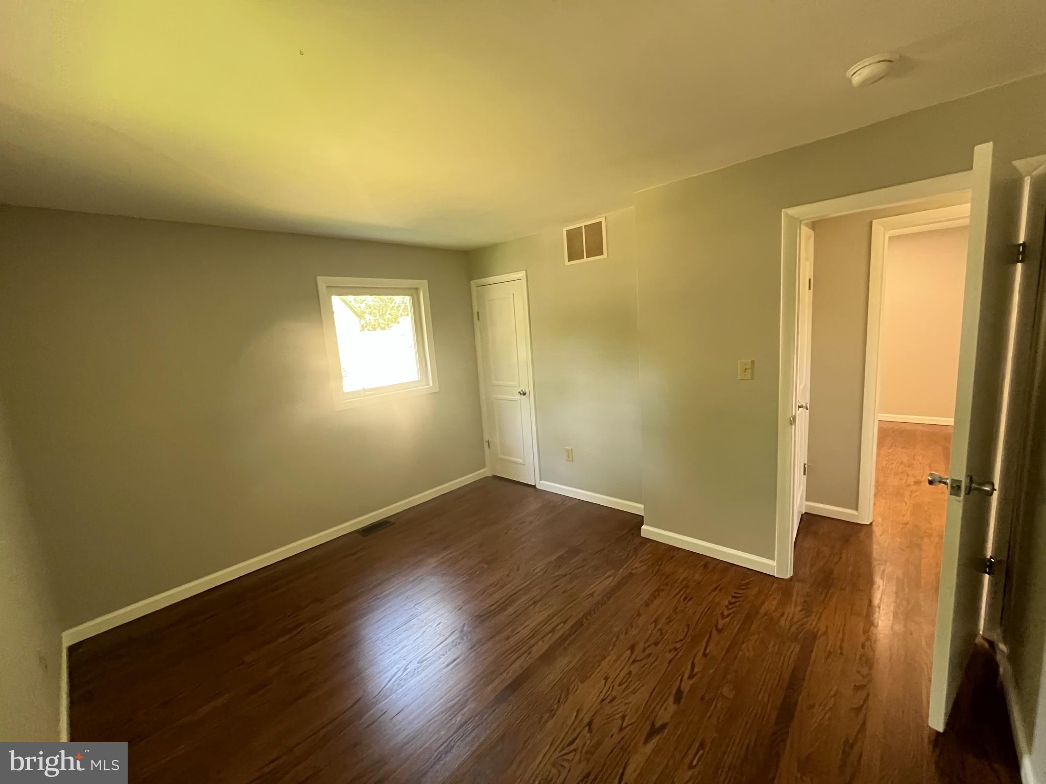 13 Meehan Boulevard Clementon, NJ 08021 - Photo 23 of 32 a view of an empty room with wooden floor and a window