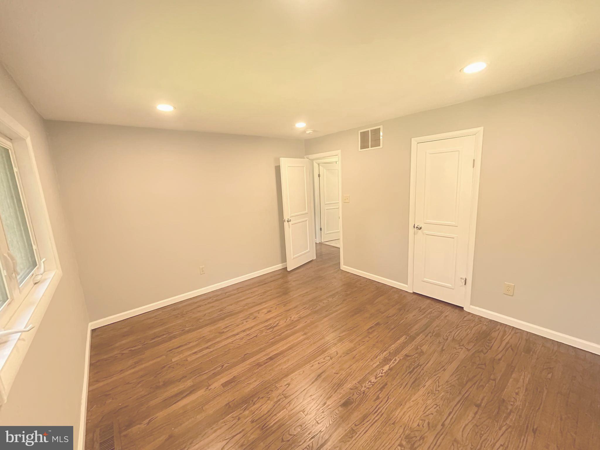 13 Meehan Boulevard Clementon, NJ 08021 - Photo 24 of 32 an empty room with wooden floor and windows