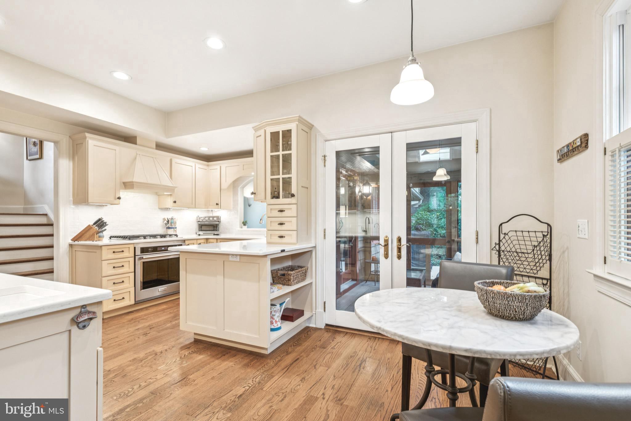 9 Tolson Street Annapolis, MD 21401 - Photo 15 of 82 a kitchen with kitchen island a stove a table and chairs