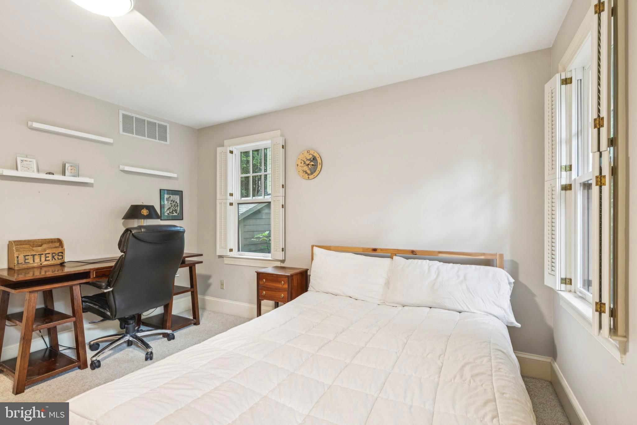 9 Tolson Street Annapolis, MD 21401 - Photo 41 of 82 a bedroom with a bed a desk and chair with wooden floor