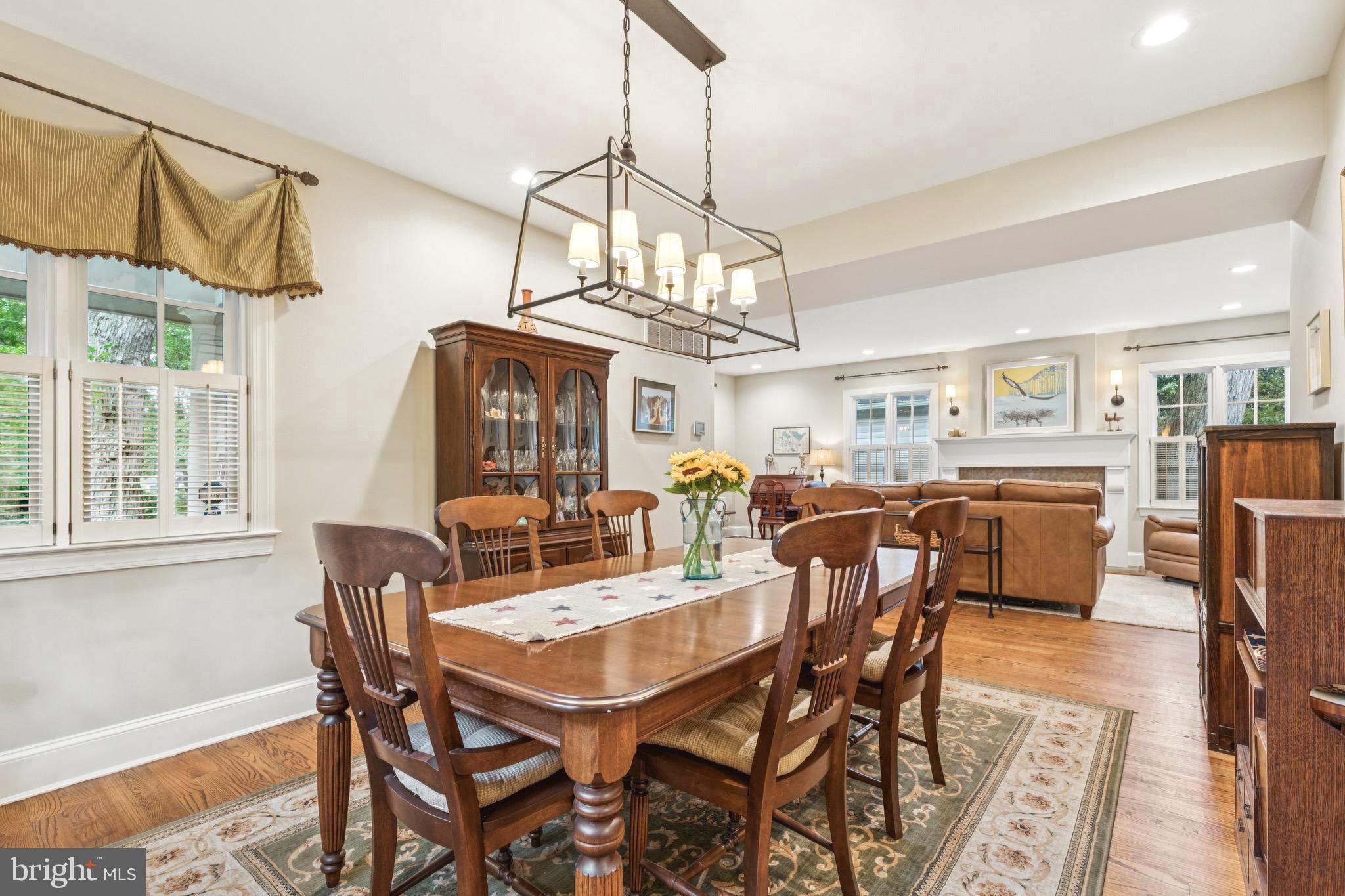 9 Tolson Street Annapolis, MD 21401 - Photo 10 of 82 a dining room with wooden floor a chandelier a wooden table and chairs