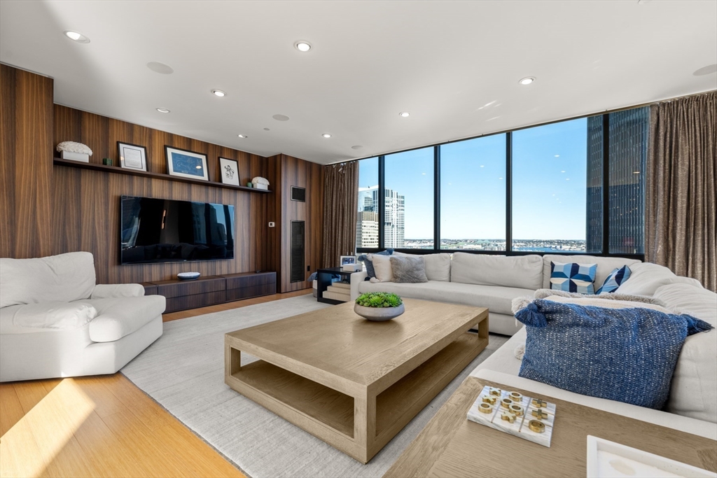 45 Province Street, Unit 2404 Boston, MA 02108 - Photo 1 of 32 a living room with furniture and a flat screen tv
