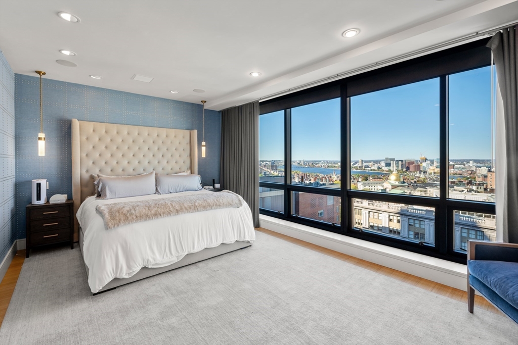 45 Province Street, Unit 2404 Boston, MA 02108 - Photo 12 of 32 a spacious bedroom with a large bed and a large window