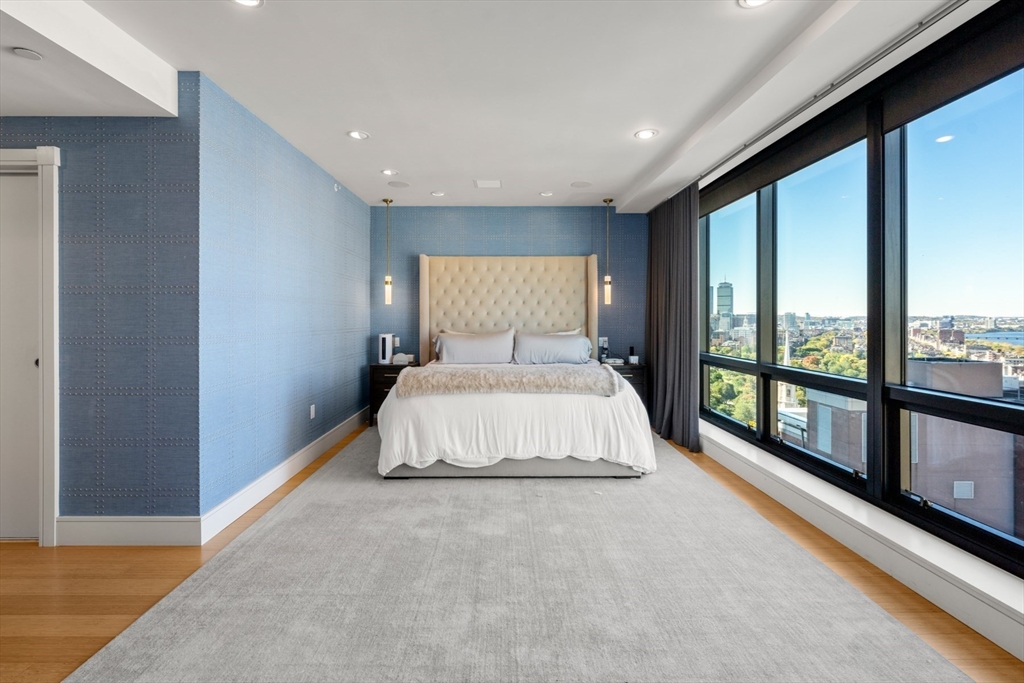 45 Province Street, Unit 2404 Boston, MA 02108 - Photo 13 of 32 a bed sitting in a spacious bedroom next to a window