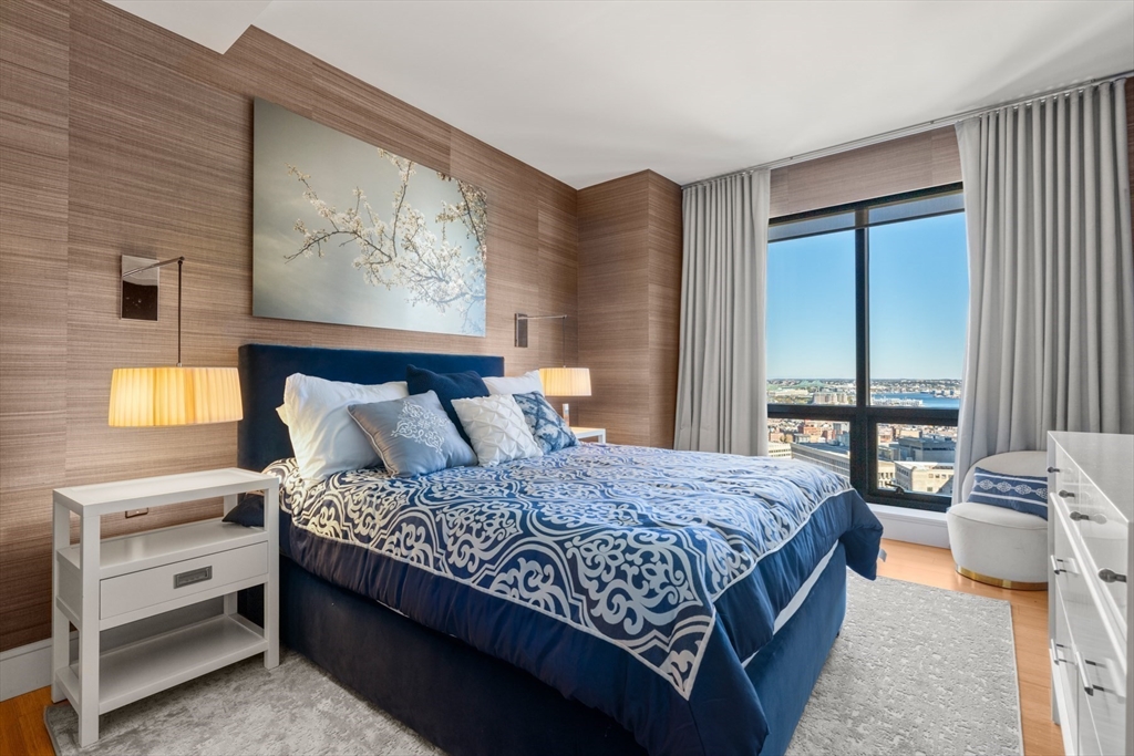 45 Province Street, Unit 2404 Boston, MA 02108 - Photo 17 of 32 a bedroom with a large bed and a window