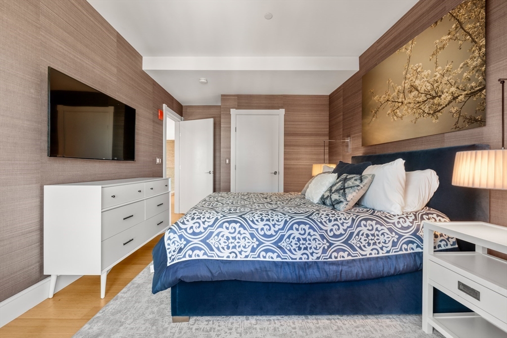 45 Province Street, Unit 2404 Boston, MA 02108 - Photo 18 of 32 a bedroom with a bed and a flat screen tv