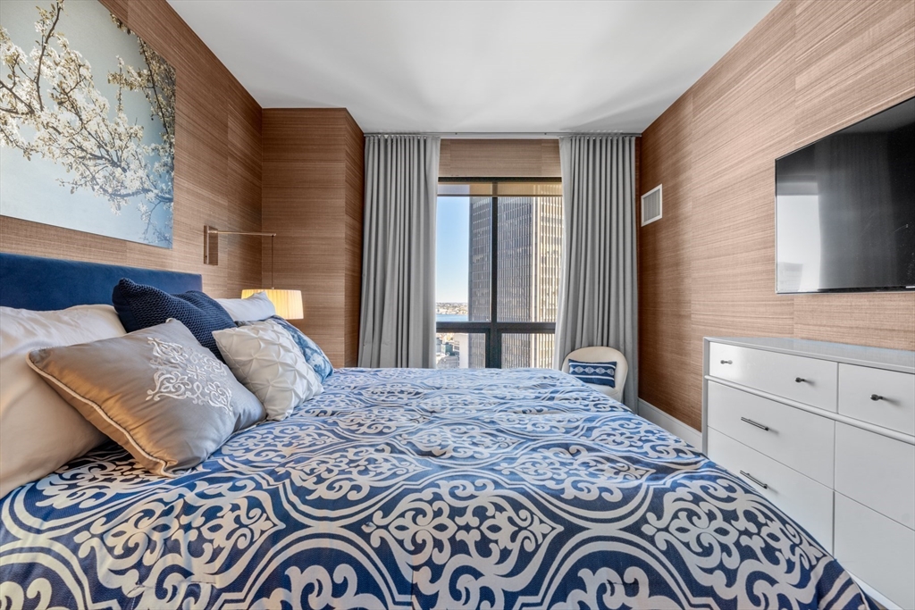 45 Province Street, Unit 2404 Boston, MA 02108 - Photo 19 of 32 a bedroom with a bed and a window