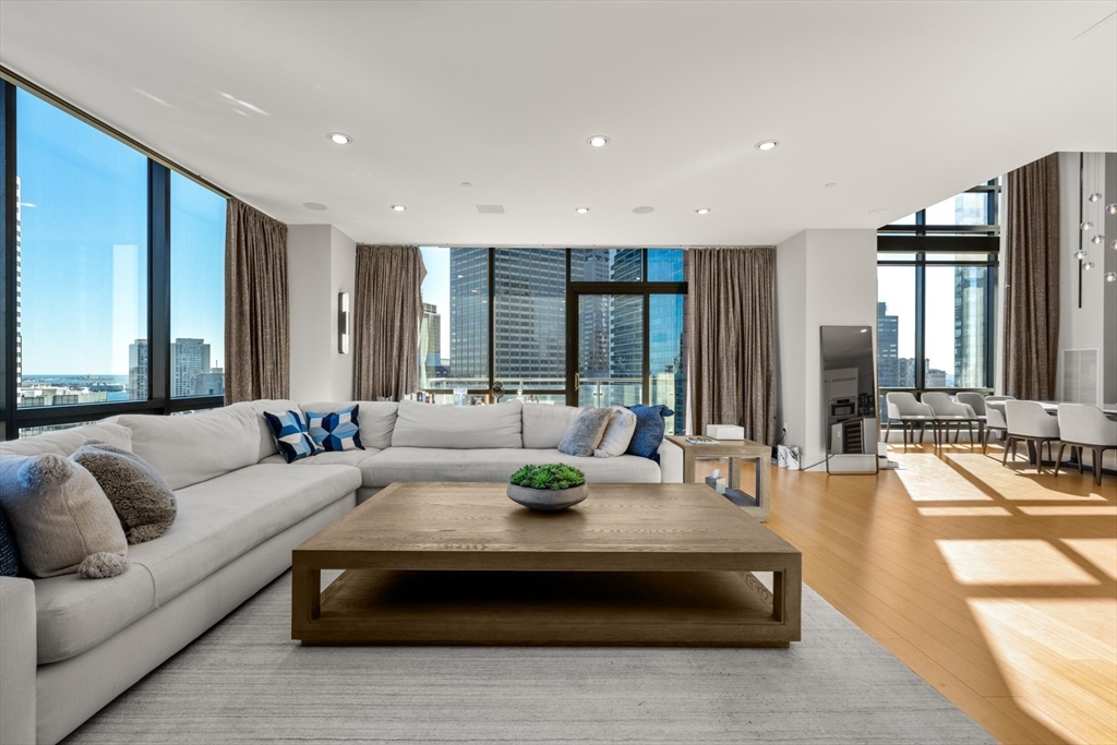 45 Province Street, Unit 2404 Boston, MA 02108 - Photo 2 of 32 a living room with furniture and large windows