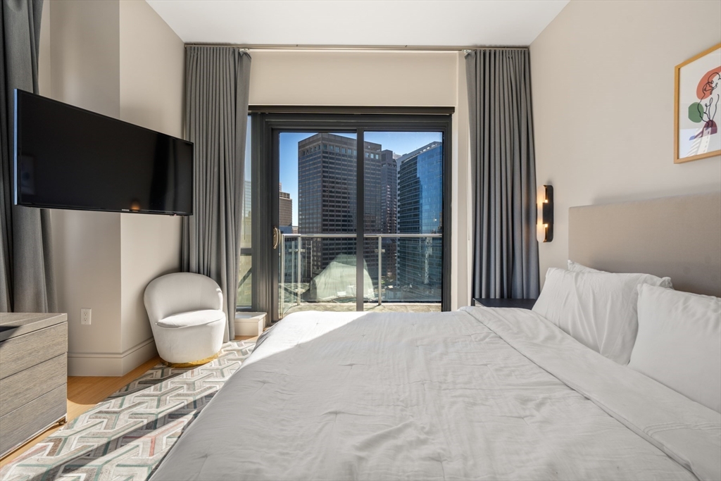 45 Province Street, Unit 2404 Boston, MA 02108 - Photo 21 of 32 a bedroom with a bed and a large window