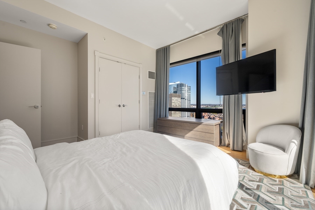 45 Province Street, Unit 2404 Boston, MA 02108 - Photo 22 of 32 a bedroom with a bed and a flat screen tv