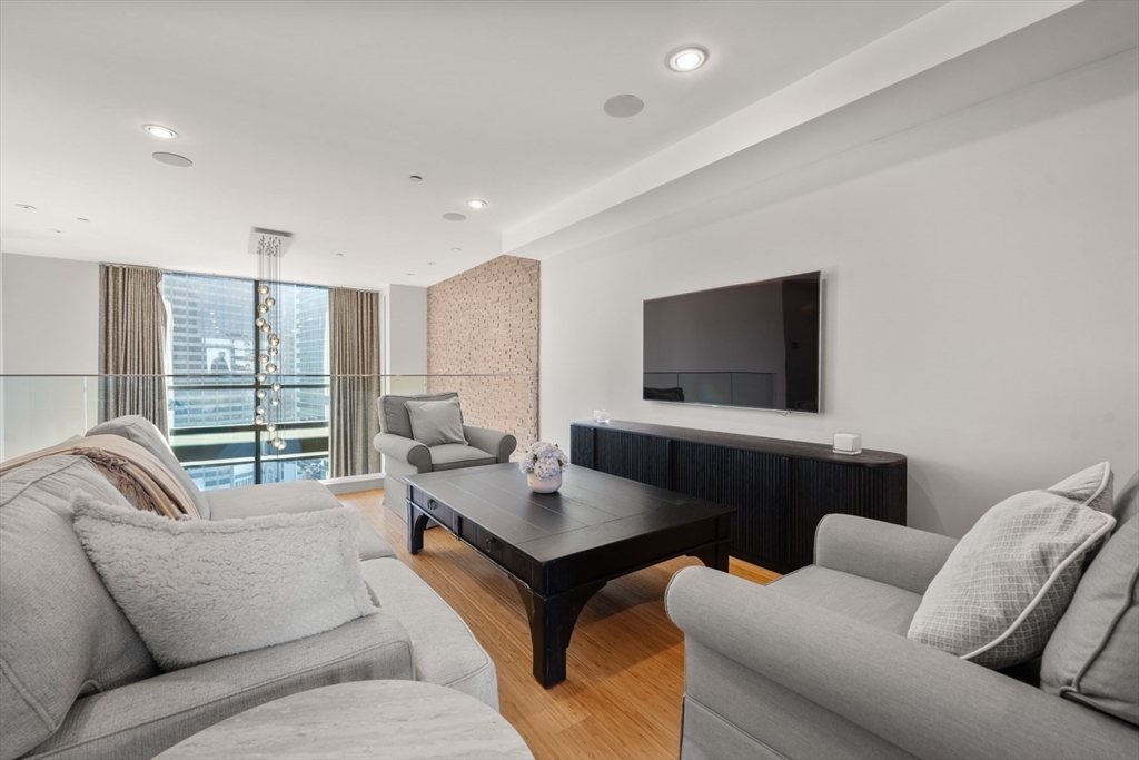 45 Province Street, Unit 2404 Boston, MA 02108 - Photo 24 of 32 a living room with furniture and a flat screen tv