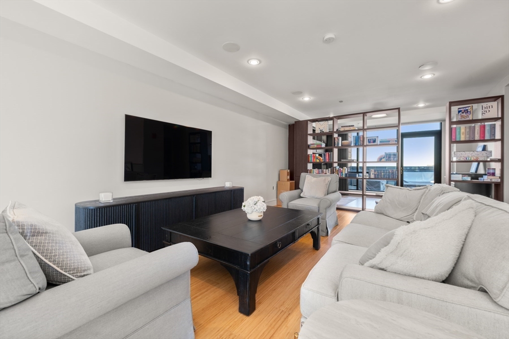 45 Province Street, Unit 2404 Boston, MA 02108 - Photo 26 of 32 a living room with furniture and a flat screen tv