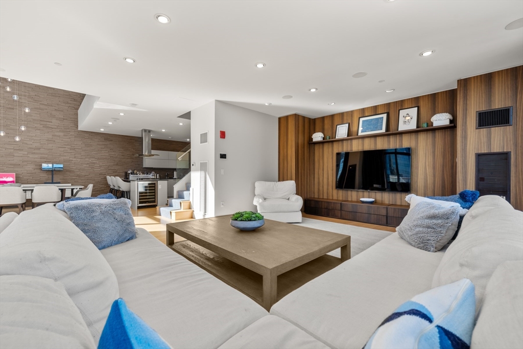 45 Province Street, Unit 2404 Boston, MA 02108 - Photo 4 of 32 a living room with furniture and a flat screen tv