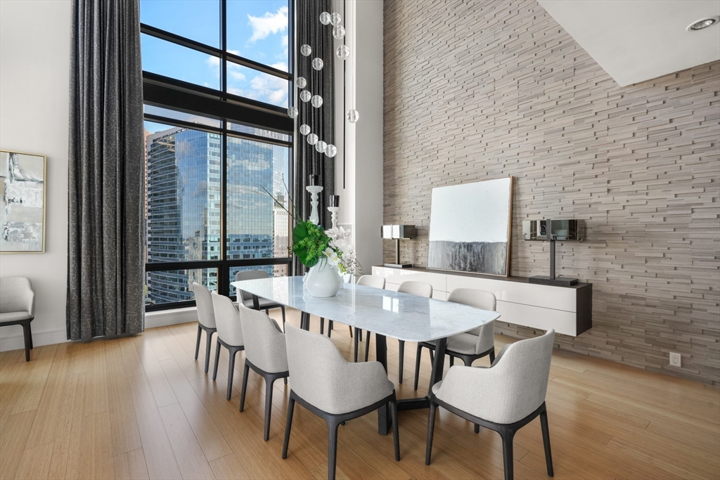 45 Province Street, Unit 2404 Boston, MA 02108 - Photo 8 of 32 a view of a dining room with furniture and wooden floor