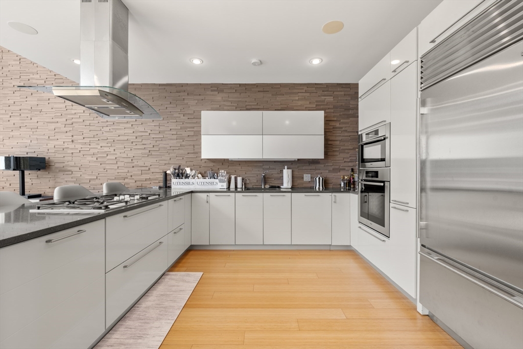 45 Province Street, Unit 2404 Boston, MA 02108 - Photo 9 of 32 a kitchen with stainless steel appliances a refrigerator and a sink