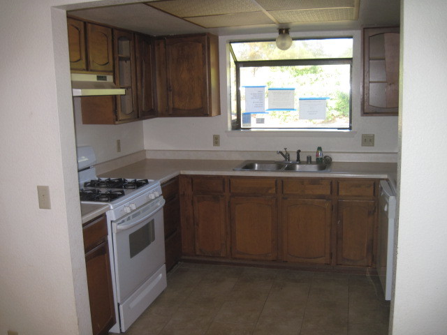 1325 Woodside Meadows Road Redding, CA 96002 - Photo 3 of 12 a kitchen with stainless steel appliances granite countertop a sink stove and refrigerator