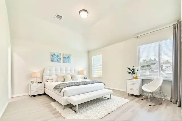 a bedroom with a bed and a table