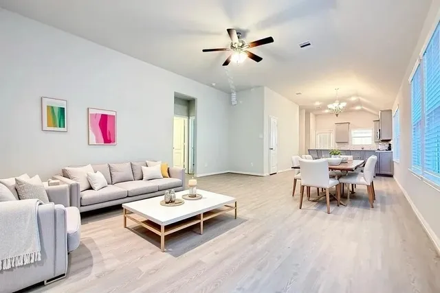 a living room with furniture and wooden floor