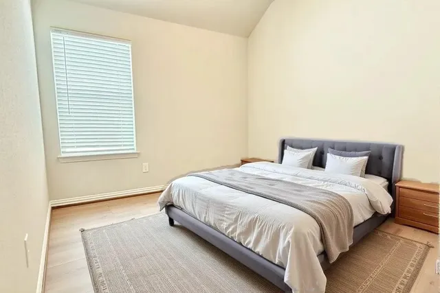 a bedroom with a bed and a window