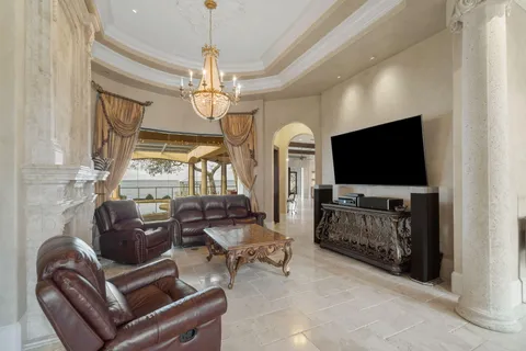 a dining room with furniture and chandelier