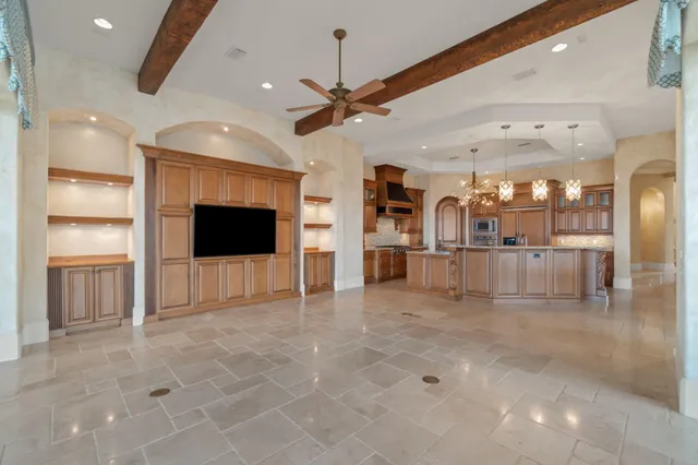 a spacious bathroom with a granite countertop double vanity sink mirror and a bathtub