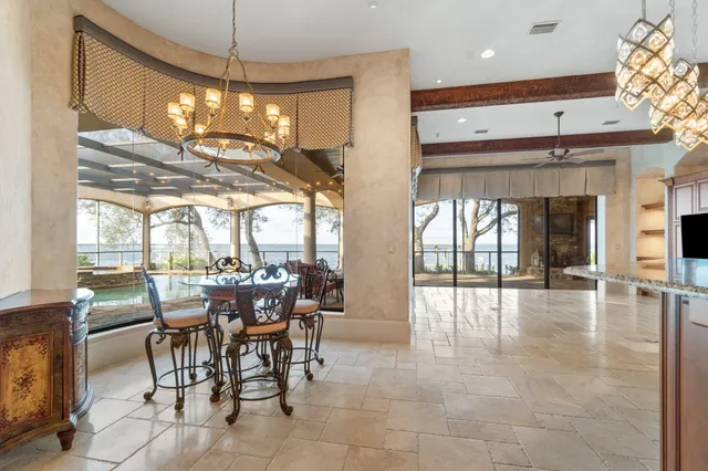 a bedroom with a large bed and a chandelier