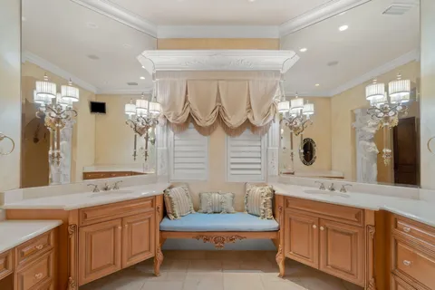 a bedroom with a large bed and a chandelier