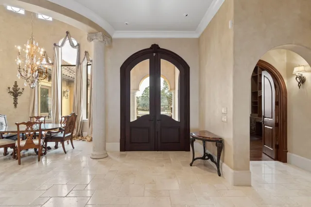 a living room with furniture a fireplace and chandelier