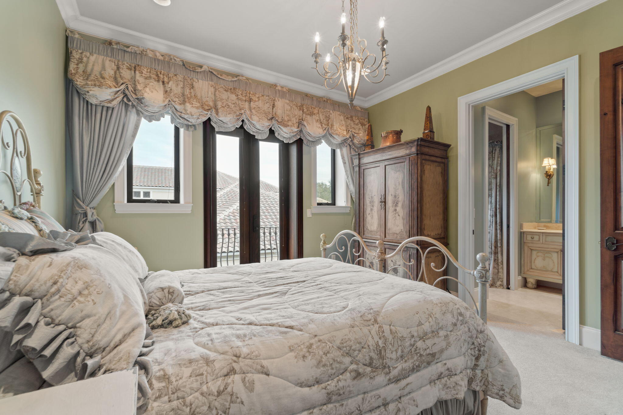 456 Captains Circle Destin, FL 32541 - Photo 62 of 85 a bedroom with a large bed and a chandelier