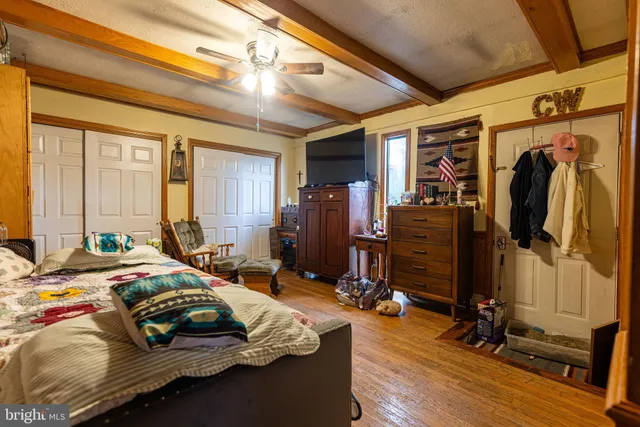 a bed sitting in a bedroom next to a window