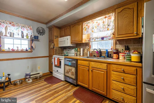 a kitchen view of a stove and a refrigerator