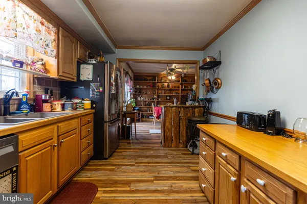 a view of room with a empty space and wooden shelves