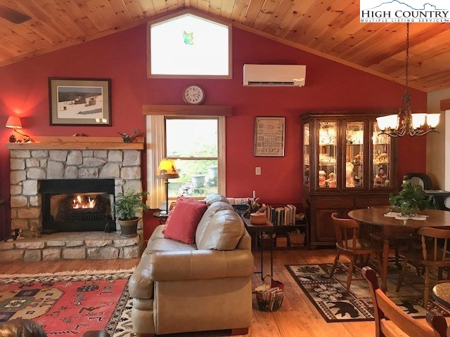 990 Fox Meadow Road Banner Elk, NC 28604 - Photo 15 of 45 a living room with furniture a window and a fireplace