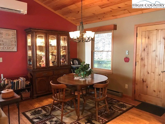 990 Fox Meadow Road Banner Elk, NC 28604 - Photo 18 of 45 a dining room with furniture a chandelier and wooden floor