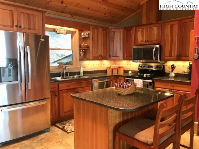 990 Fox Meadow Road Banner Elk, NC 28604 - Photo 19 of 45 a kitchen with stainless steel appliances granite countertop a stove a refrigerator a sink a stove and island