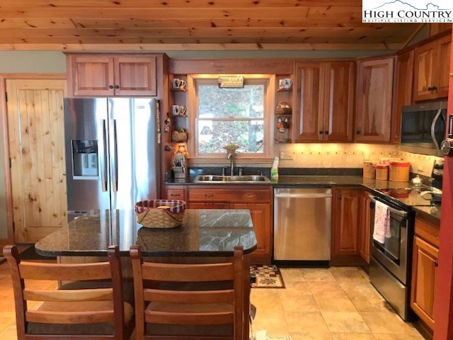 990 Fox Meadow Road Banner Elk, NC 28604 - Photo 21 of 45 a kitchen with a refrigerator and a stove