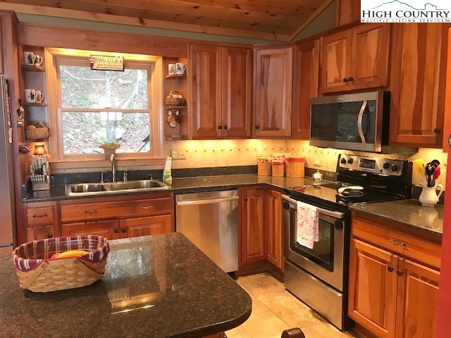990 Fox Meadow Road Banner Elk, NC 28604 - Photo 22 of 45 a kitchen with stainless steel appliances granite countertop a sink stove and cabinets