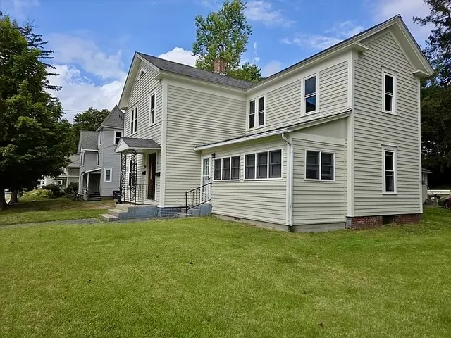 a front view of a house with a garden