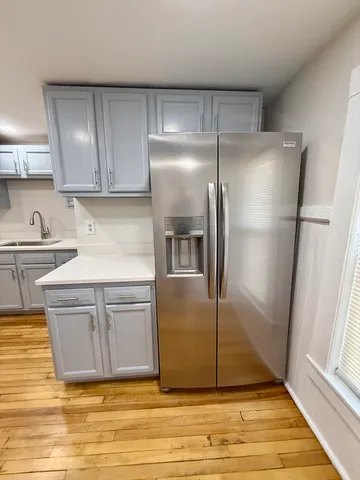 a kitchen with kitchen island a counter top space cabinets and stainless steel appliances