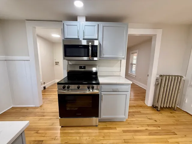 a kitchen with a stove and a microwave