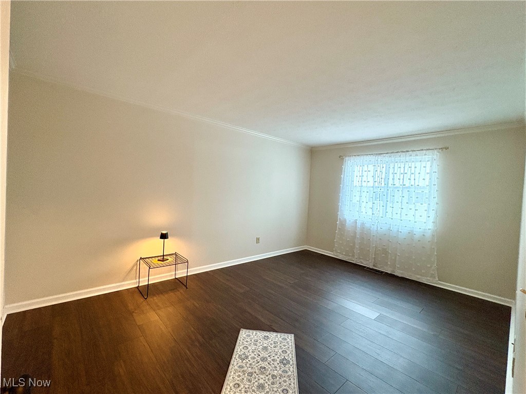 4015 Marks Road, Unit 3C Medina, OH 44256 - Photo 16 of 36 Empty room featuring dark hardwood / wood-style flooring and ornamental molding