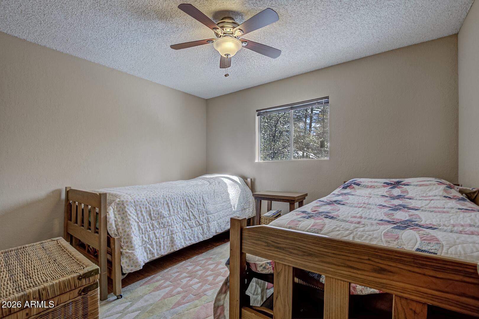 3741 Cochise Lane Pine, AZ 85544 - Photo 13 of 21 a bedroom with a bed and a chandelier
