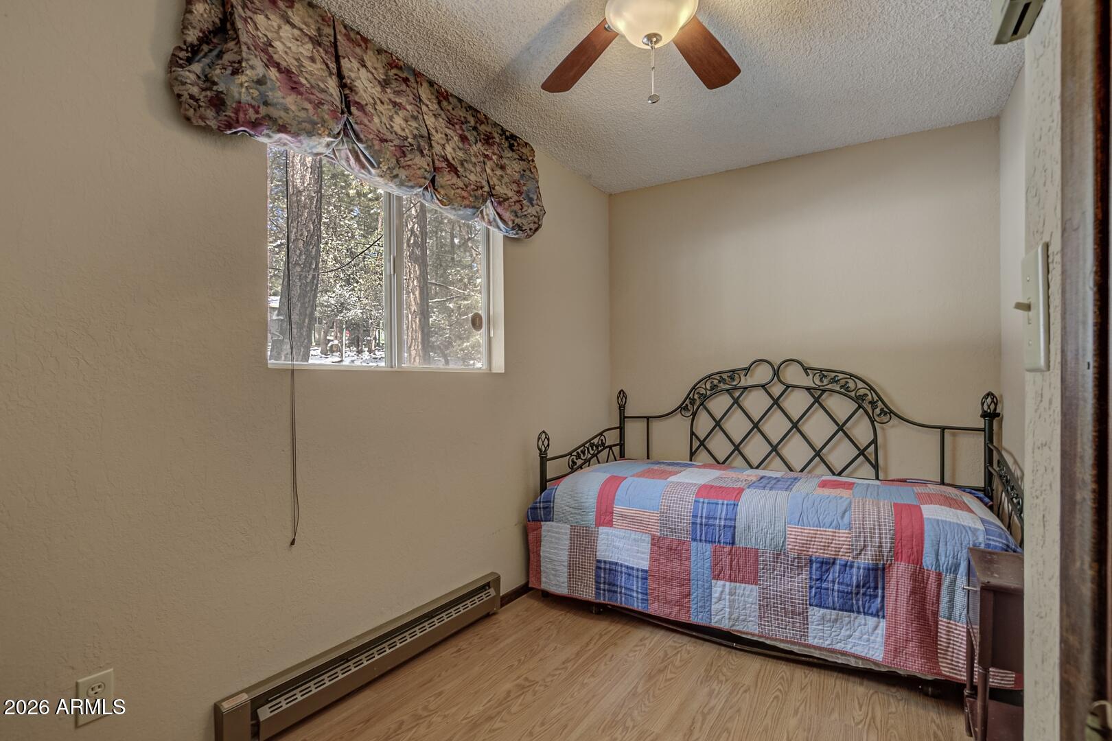 3741 Cochise Lane Pine, AZ 85544 - Photo 15 of 21 a bedroom with a bed and a chandelier