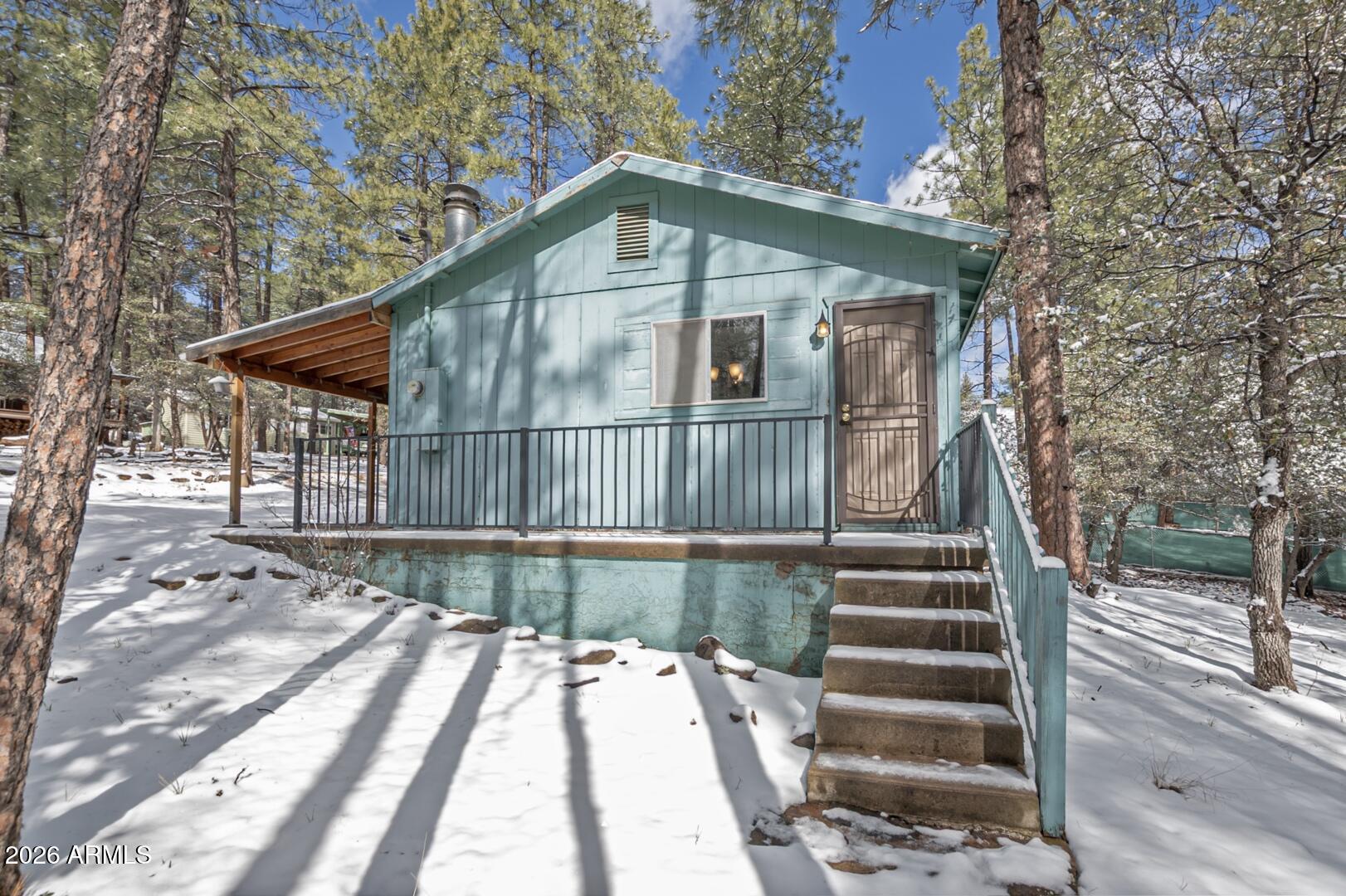 3741 Cochise Lane Pine, AZ 85544 - Photo 17 of 21 a front view of a house with a yard