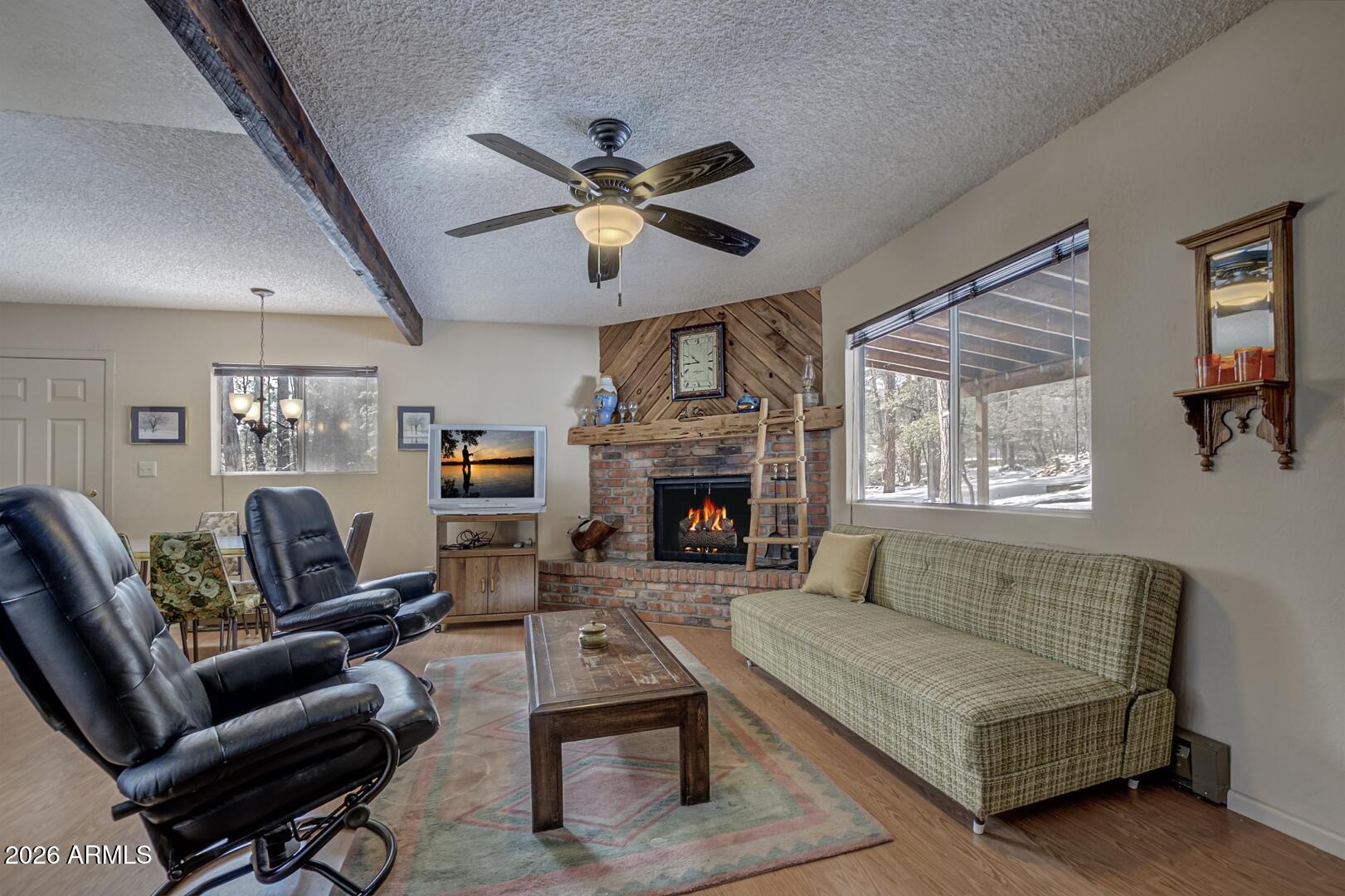 3741 Cochise Lane Pine, AZ 85544 - Photo 3 of 21 a living room with furniture and a fireplace