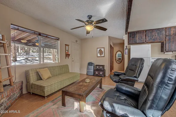 a living room with furniture a ceiling fan and a window