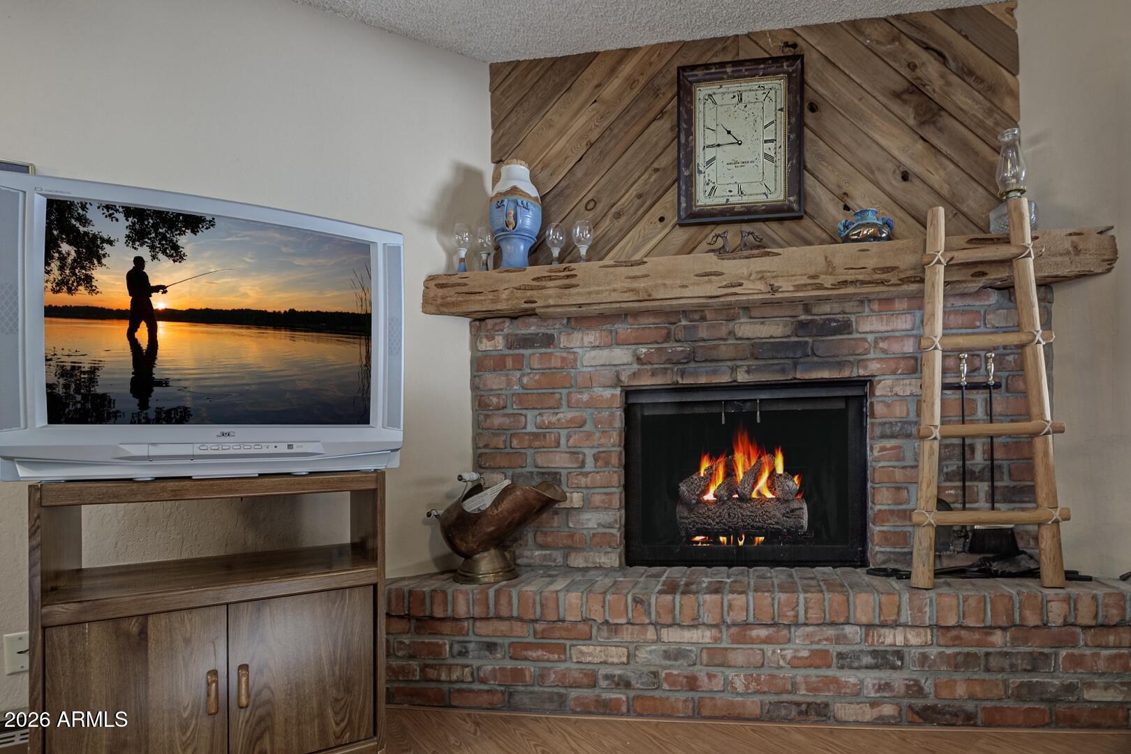 3741 Cochise Lane Pine, AZ 85544 - Photo 6 of 21 a living room with fireplace and a fireplace