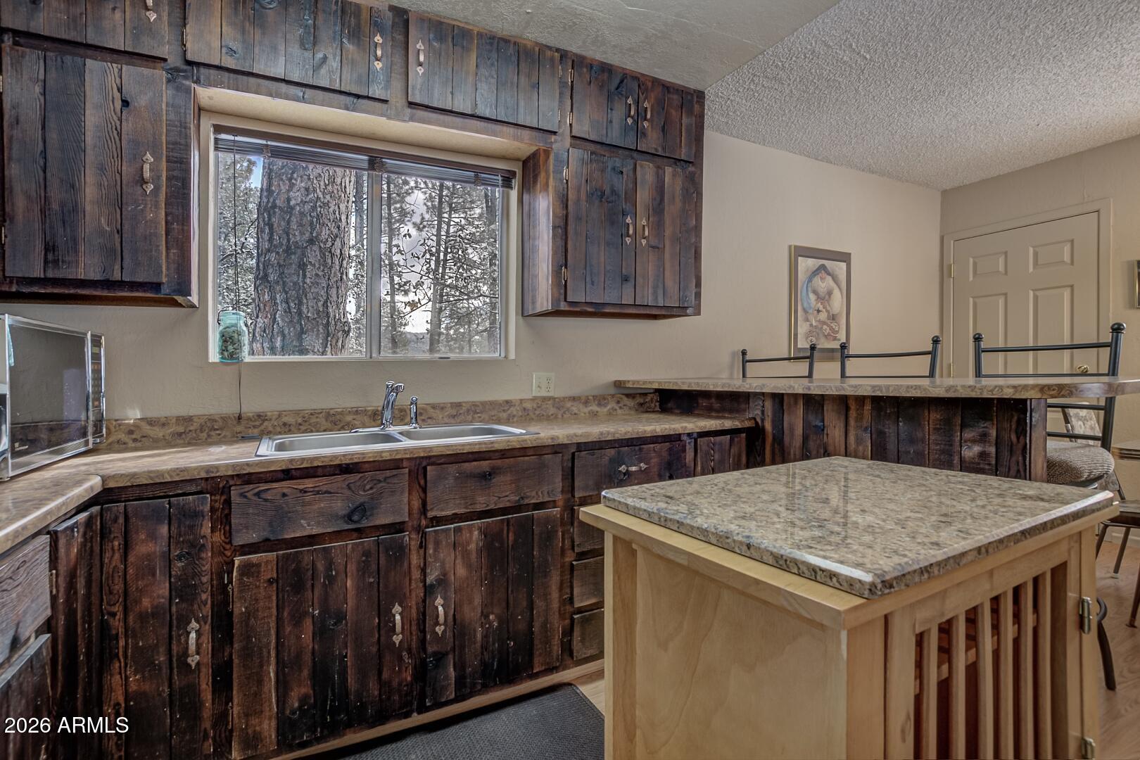3741 Cochise Lane Pine, AZ 85544 - Photo 9 of 21 a kitchen with a stove a sink and a refrigerator